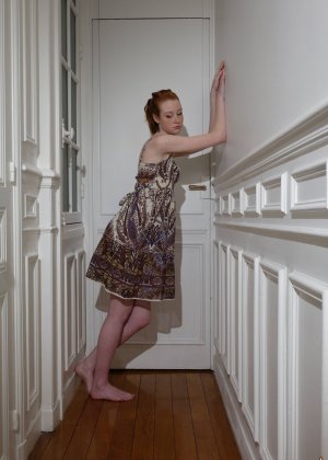 Pale redhead Nathalie Lawson exposes her upskirt underwear in a hallway
